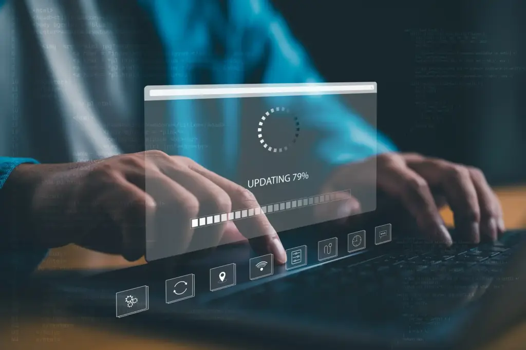 software-update Closeup of hands typing on keyboard with a heads up dislay showing a software update in progress